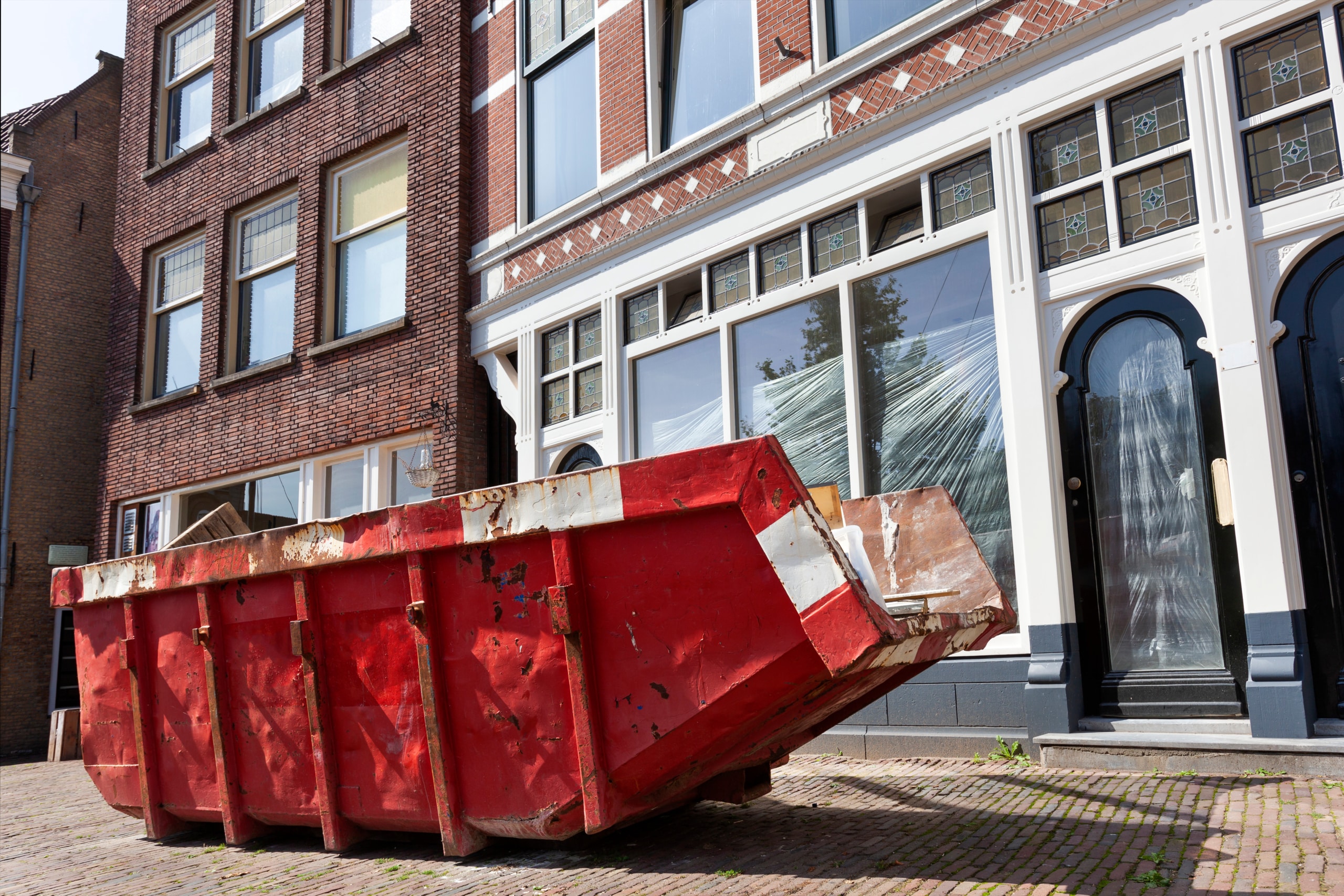 Red skip in a street in Rotterdam Red skip in a street in Rotterdam